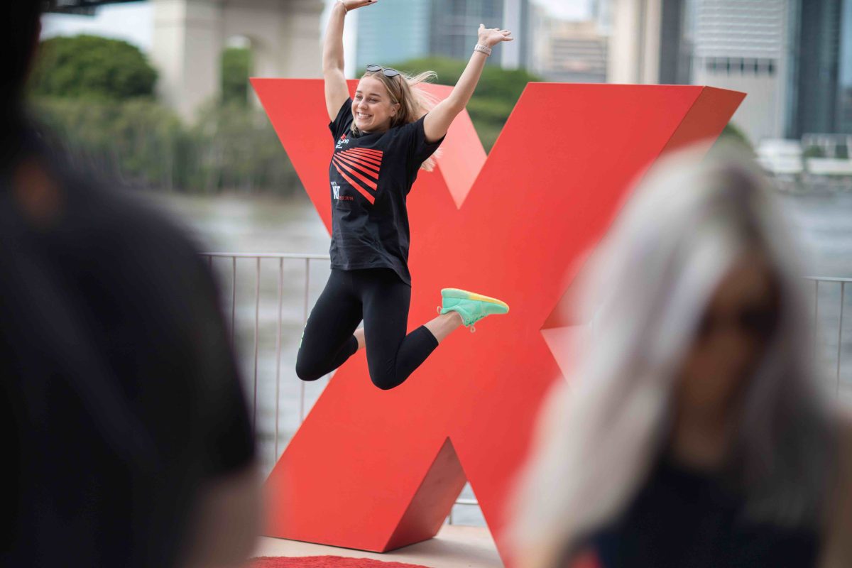 Girl jumping in front of red x