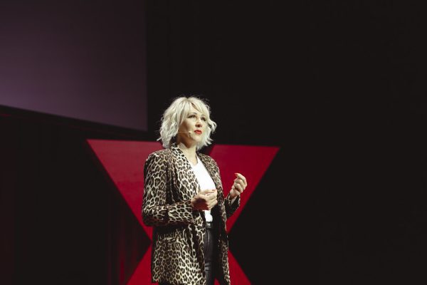 Tiana Iuvale on stage in a leopard coat and white blouse