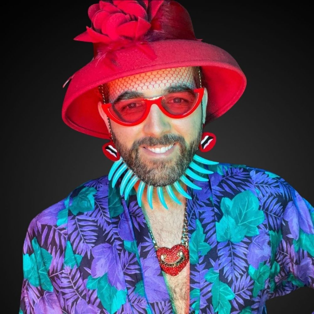 Headshot of Jordi Luke smiling against a dark background.